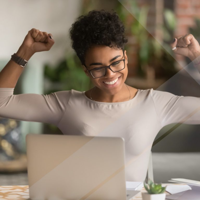 A woman at a desk celebrates the arrival of Joiin's multi-dimensional reporting feature